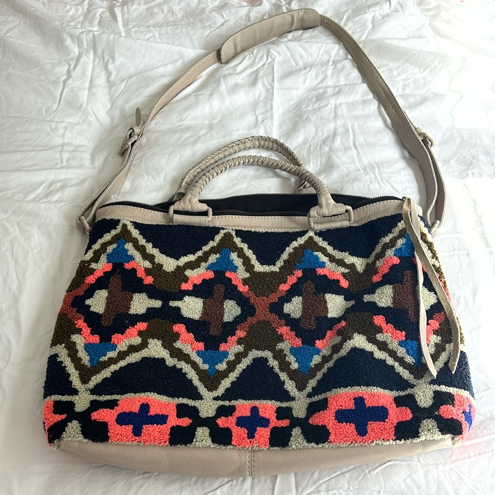 Multicolored travel bag measuring 20 inches x 13 inches